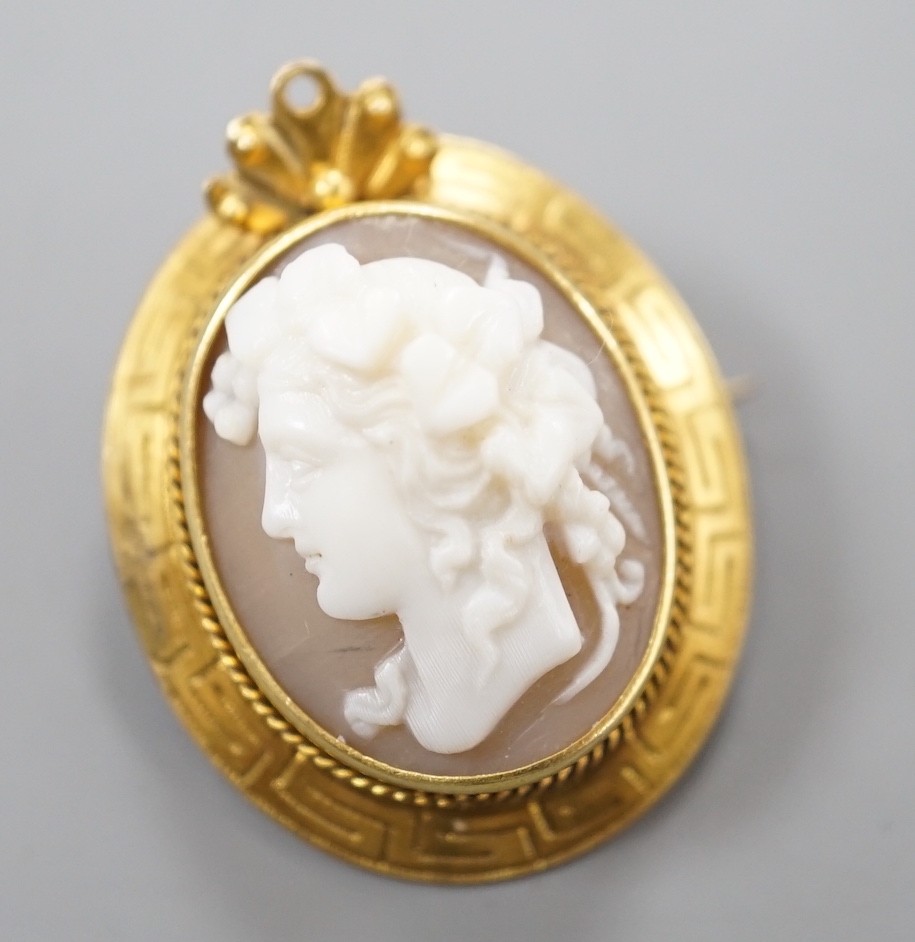A yellow metal mounted cameo shell brooch, carved with the bust of a lady to dexter, 28mm.